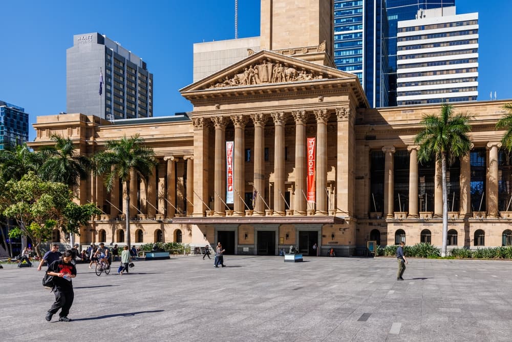 The sandstone portico and columns of Brisbane City Hall seen across King George Square.